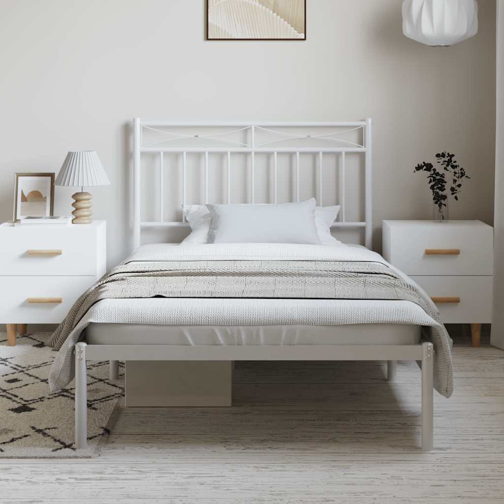 White metal bed frame with headboard and mattress in a room