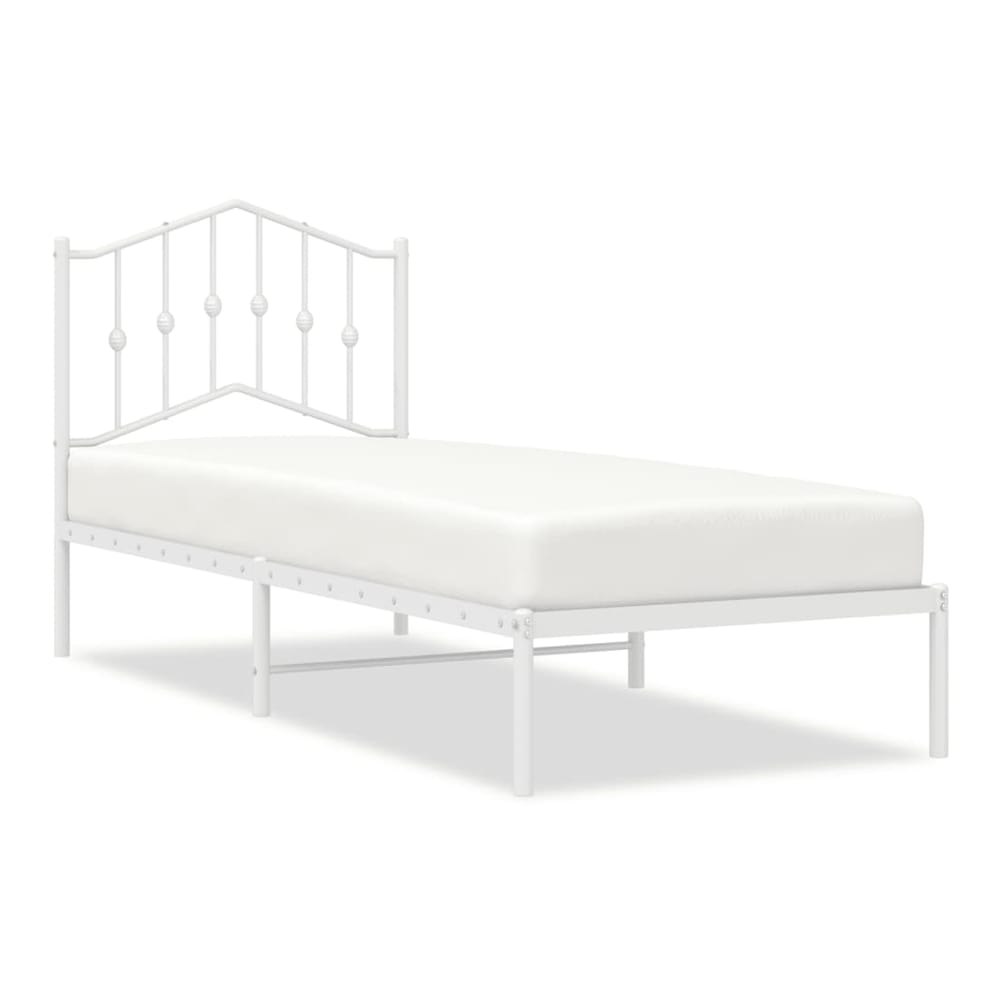white metal bed frame with a decorative headboard and a mattress
