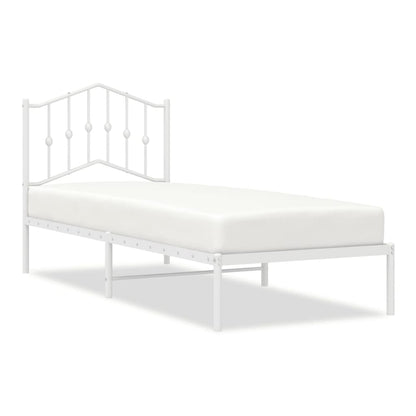 white metal bed frame with a decorative headboard and a mattress