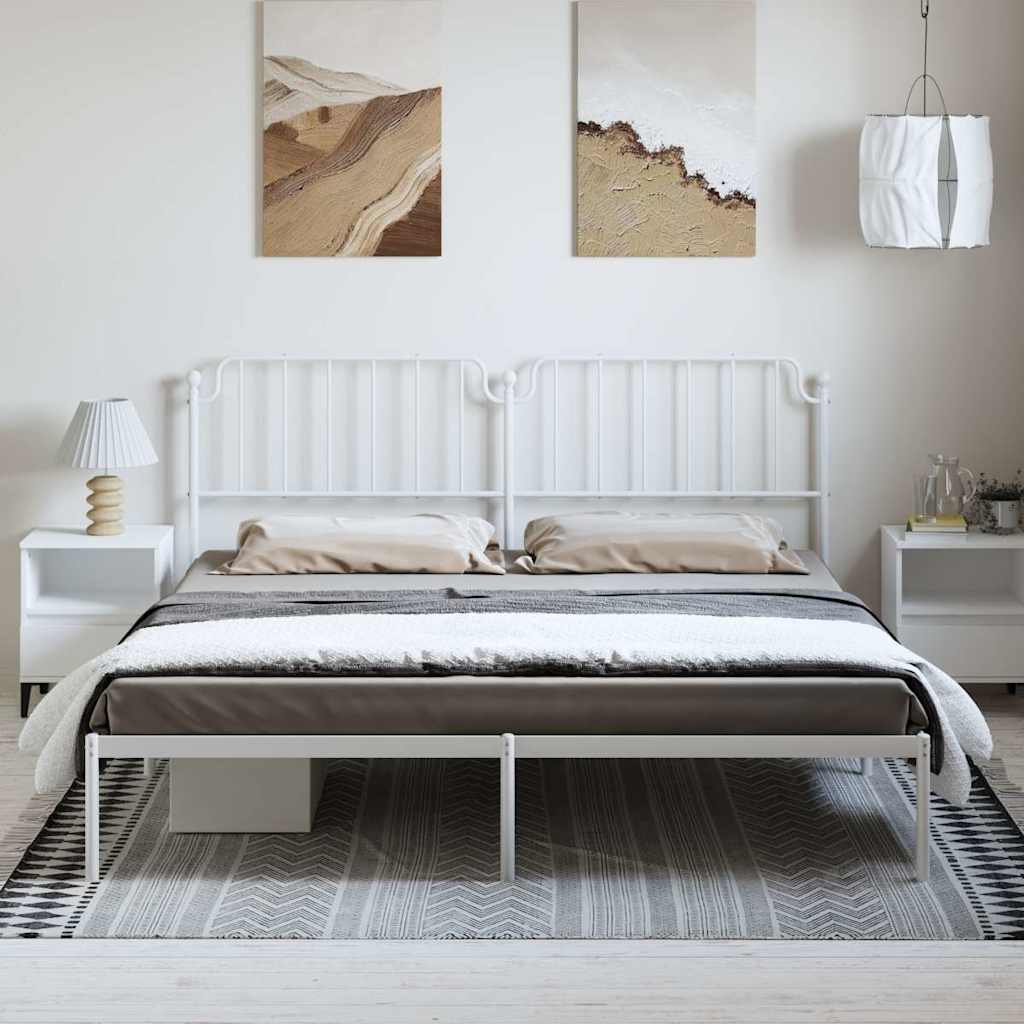 White metal bed frame with headboard and footboard in a room