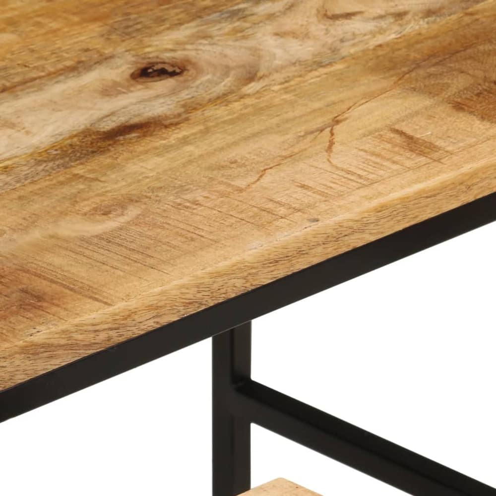 Close up of the edge of a rough mango wood tabletop and metal frame