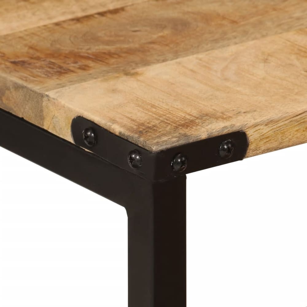 close up of the corner of a wooden table top with black metal frame and rivets