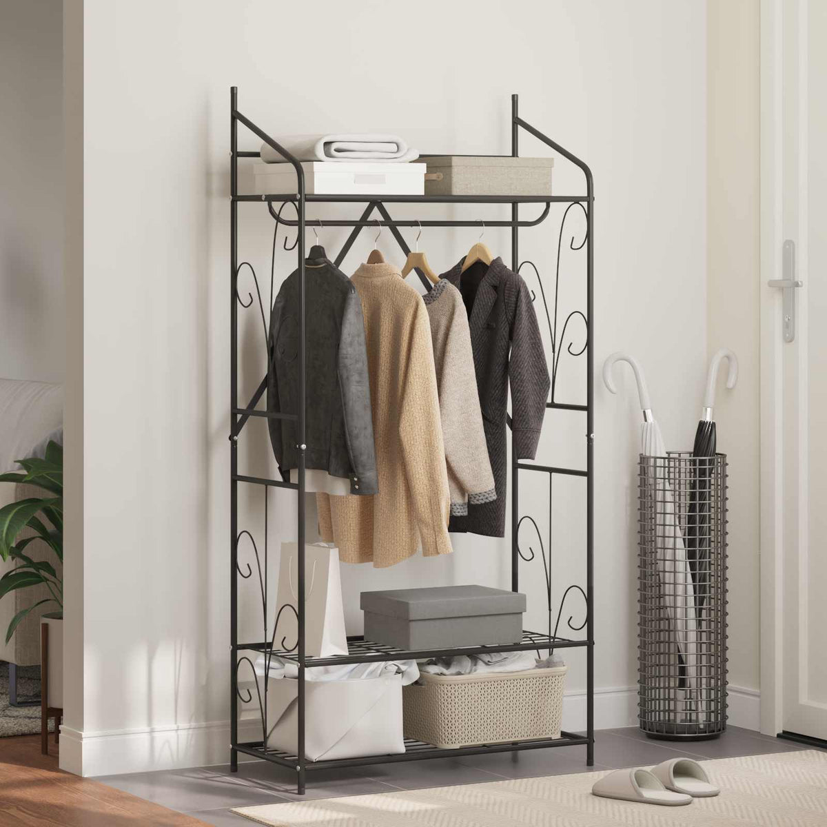The open wardrobe in a hallway with clothes, boxes and an umbrella stand