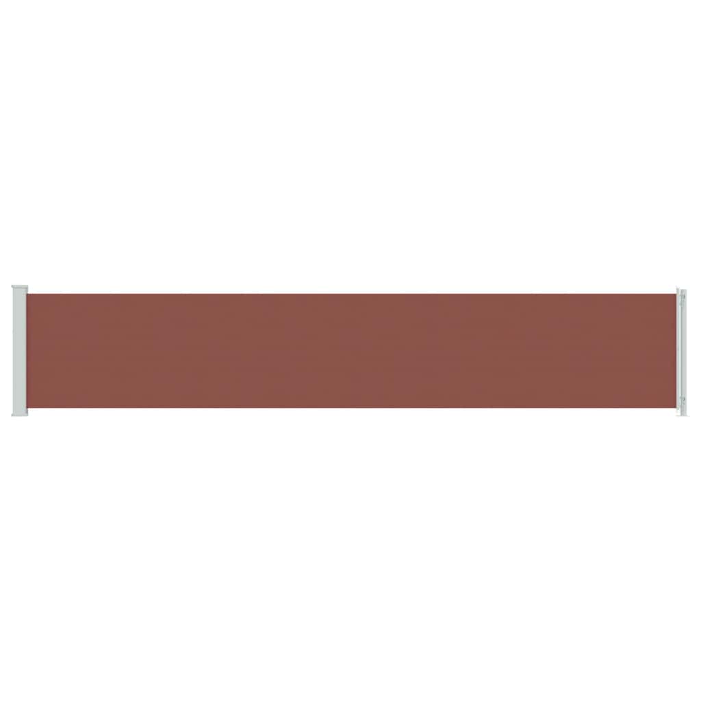 A brown retractable patio awning extended horizontally with white posts at each end