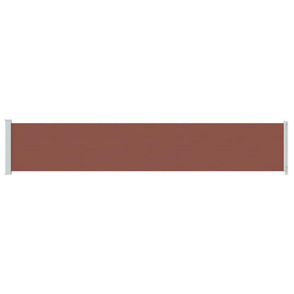 A brown retractable patio awning extended horizontally with white posts at each end