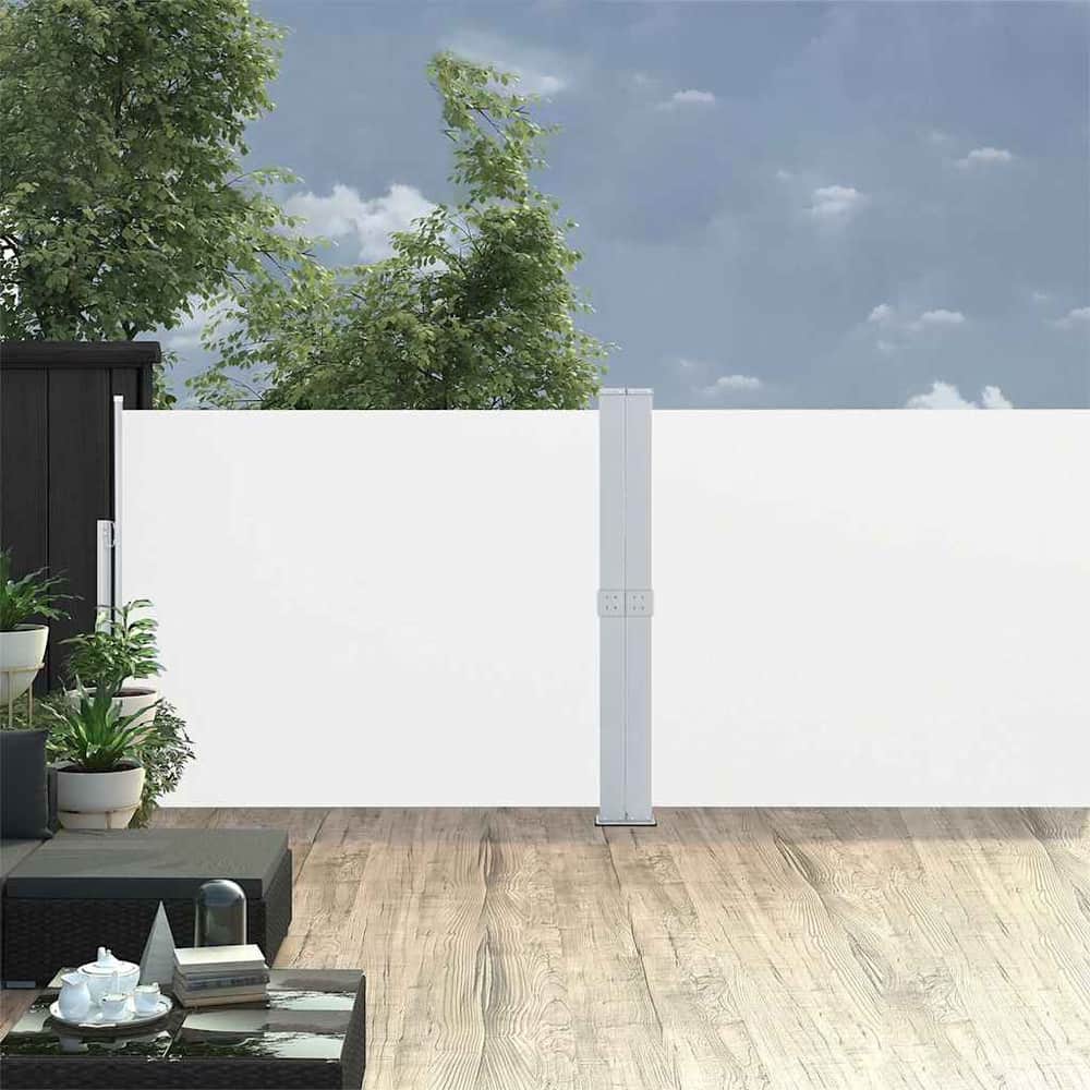 The outdoor sunshade extended on a wooden patio with plants and furniture