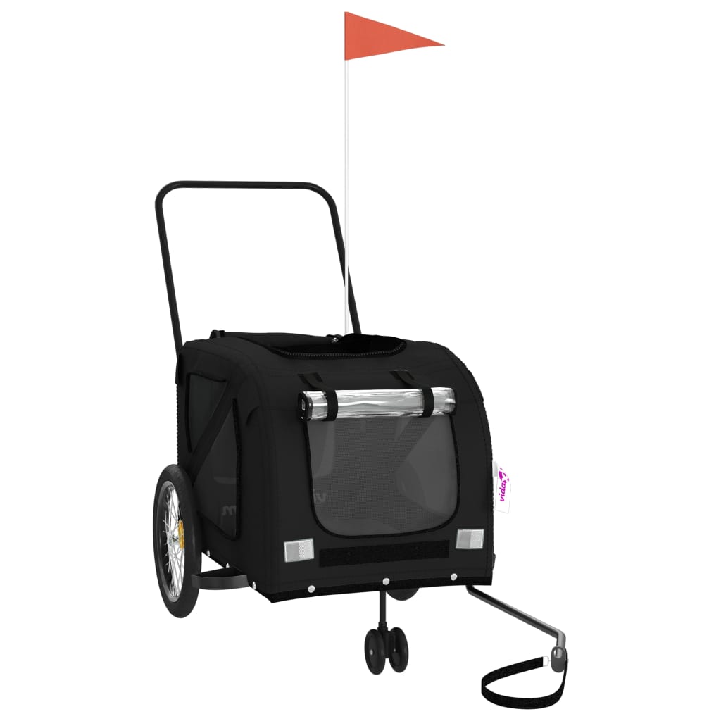 Black pet bike trailer with an orange flag on a pole, shown from the front right side