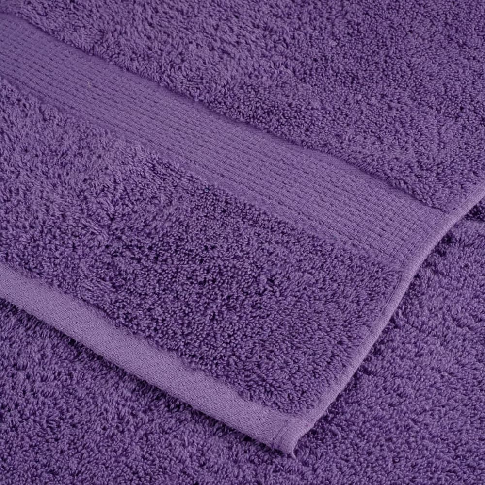 Close up of the textured fabric and woven border of a purple towel