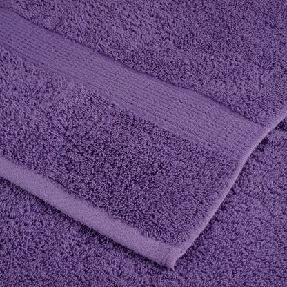Close up of the textured fabric and woven border of a purple towel
