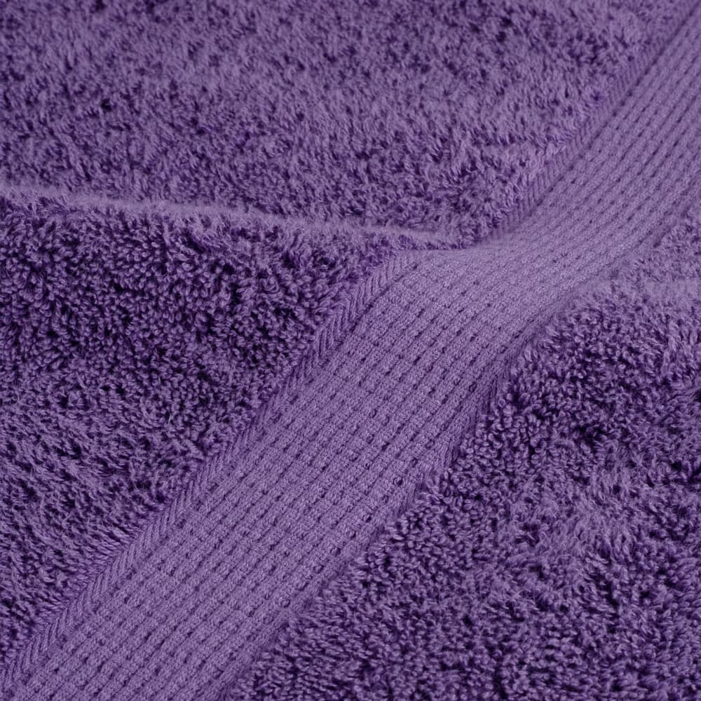 Detailed view of the woven border and plush texture of a purple towel