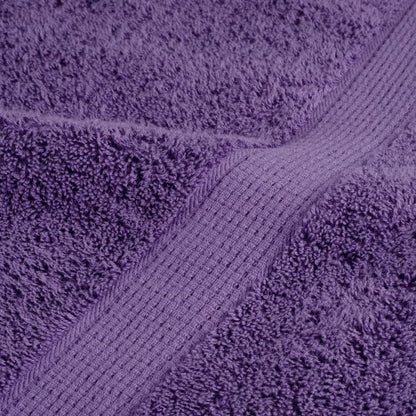 Detailed view of the woven border and plush texture of a purple towel