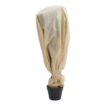 A small potted plant covered with the beige plant fleece for protection