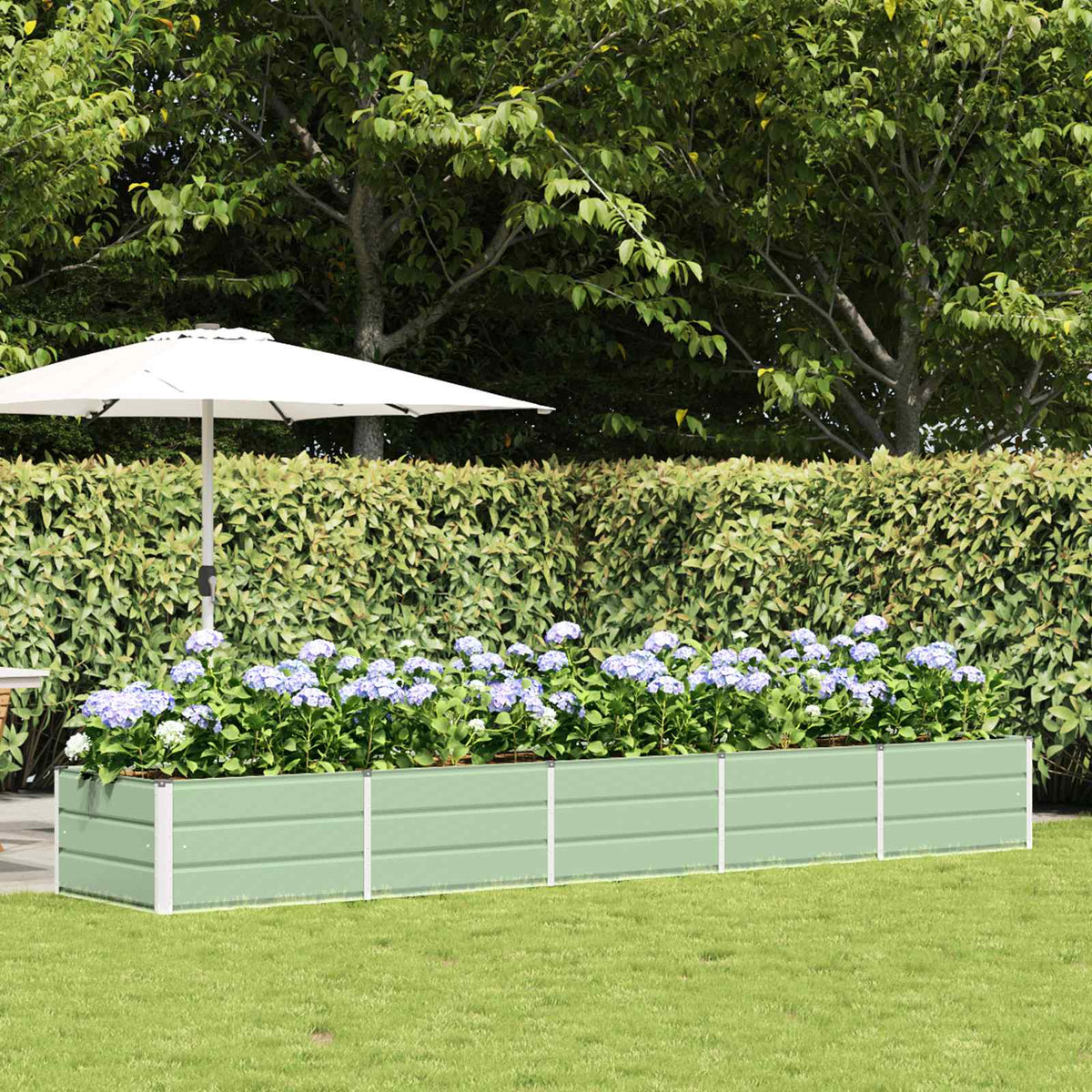 vidaXL Planter Green in a garden setting with blue flowers and a white umbrella