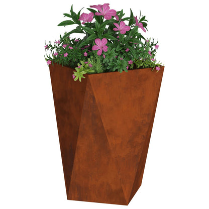 The faceted rusty weathering steel planter filled with pink flowers