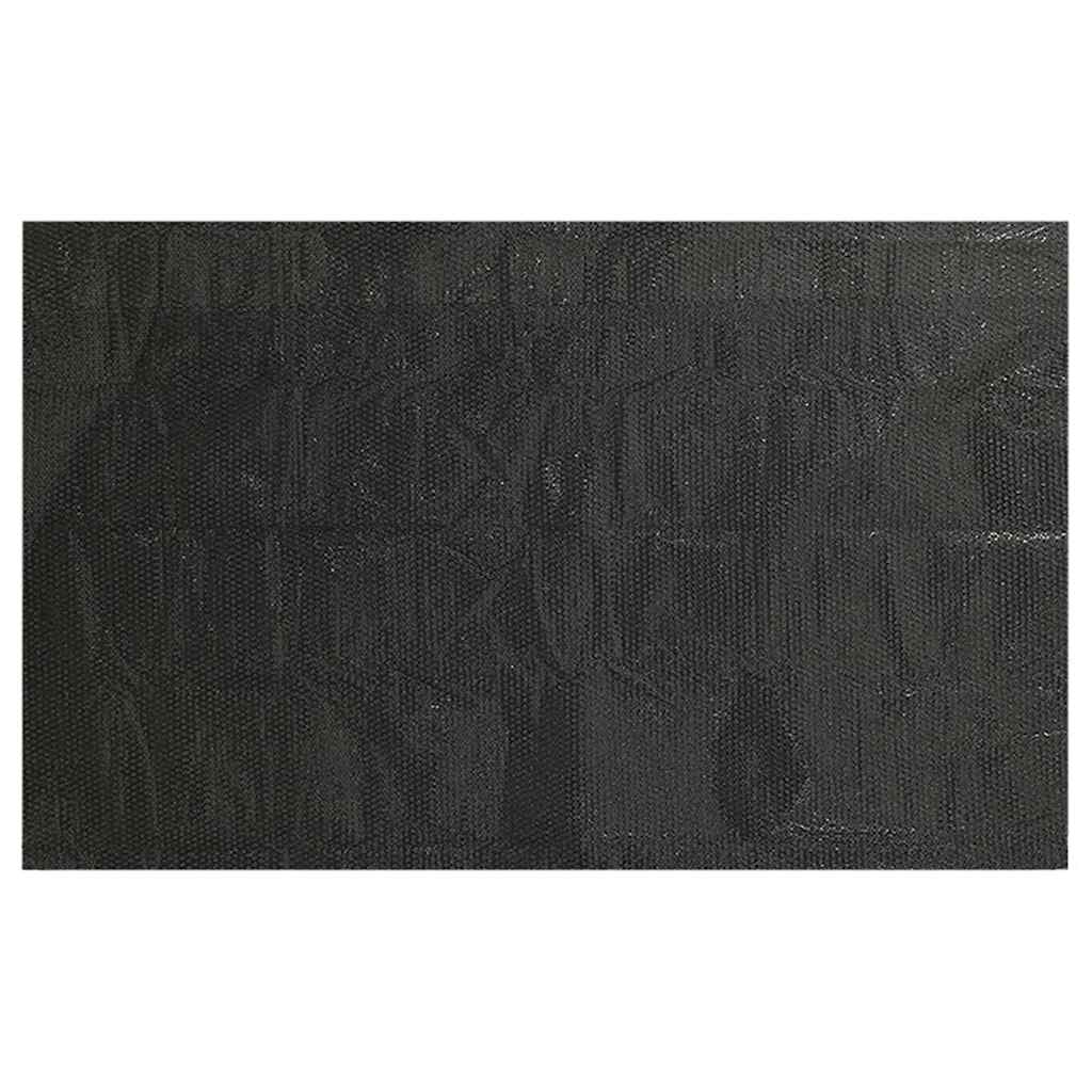 The black pool cover laid flat showing its full surface