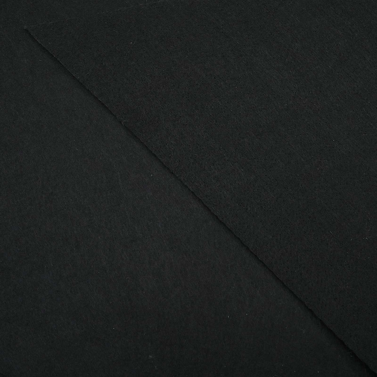 The black non-woven fabric of the pool ground cloth showing the texture of the material