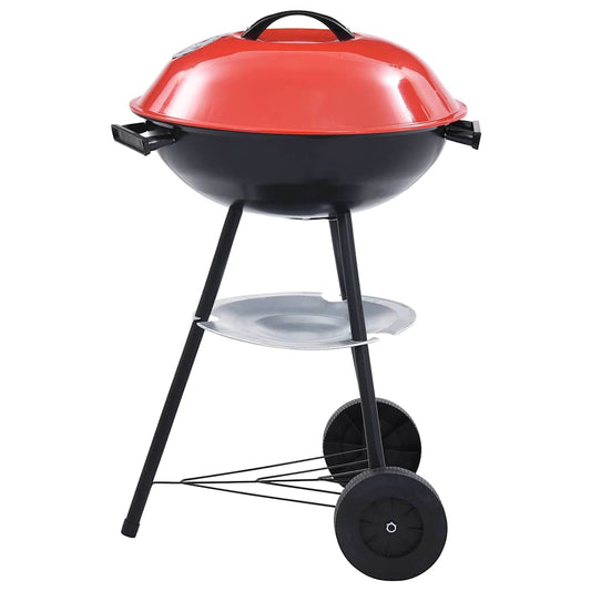 The charcoal kettle grill standing on three legs with two black wheels and a bright red lid