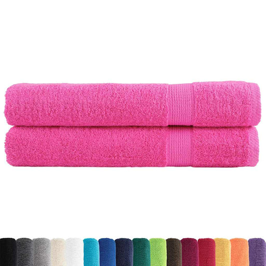 Two pink towels shown with a selection of other colours available