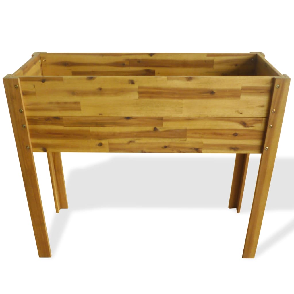 A wooden raised garden bed with four legs, viewed from a slight angle