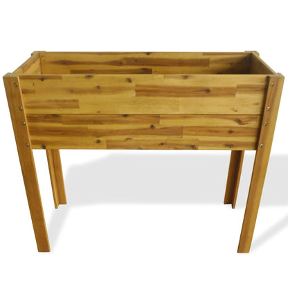 A wooden raised garden bed with four legs, viewed from a slight angle