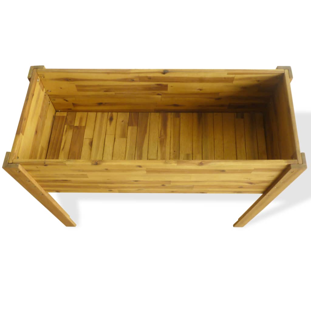 The inside of the wooden raised garden bed, showing the slatted base and wooden construction