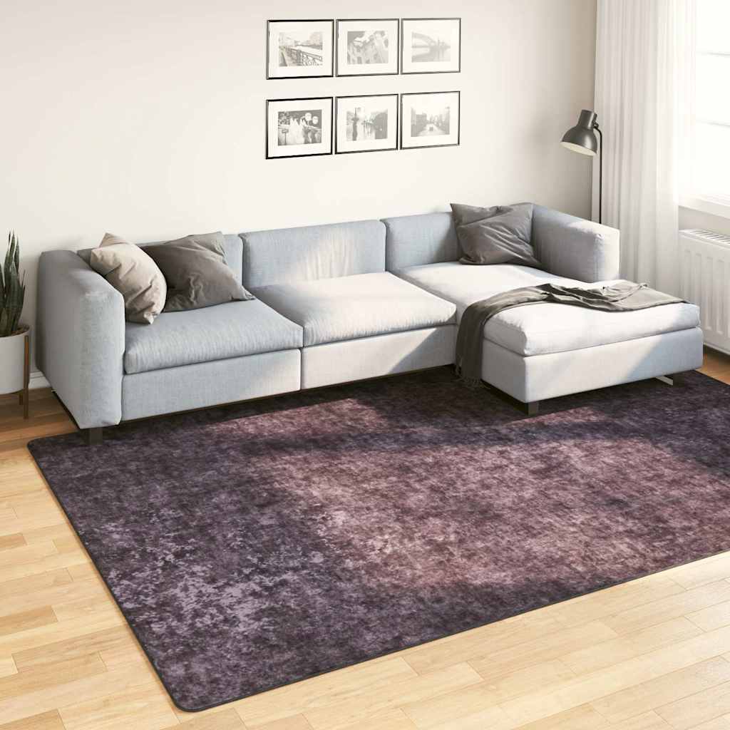 Rug Washable Anthracite placed on a wooden floor in a modern living room with a grey sofa