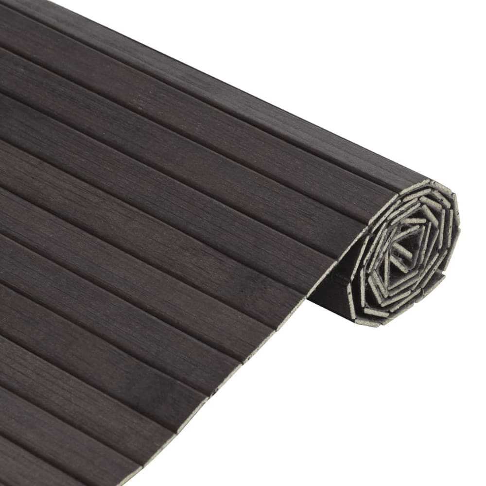 Close-up of the dark brown bamboo rug, rolled up, showing the slatted texture