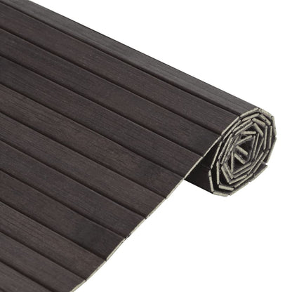 Close-up of the dark brown bamboo rug, rolled up, showing the slatted texture