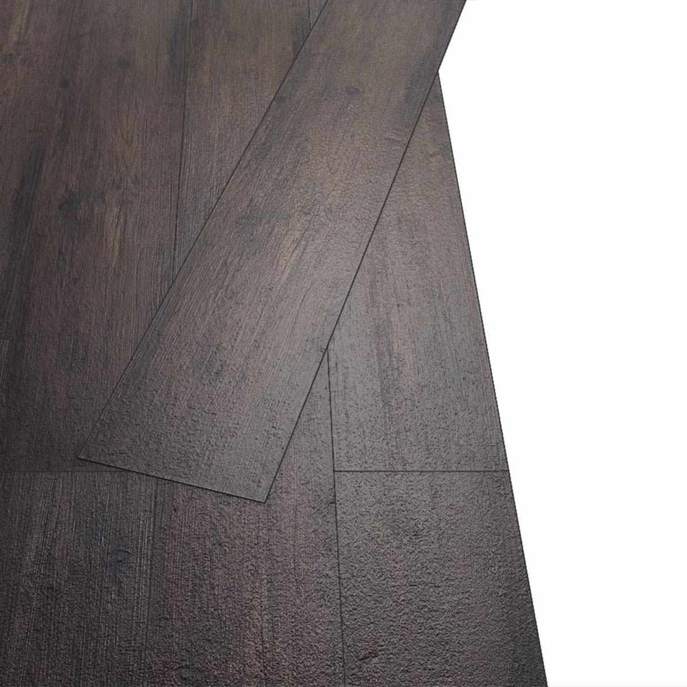 Two dark brown self-adhesive flooring planks laid together showing the join