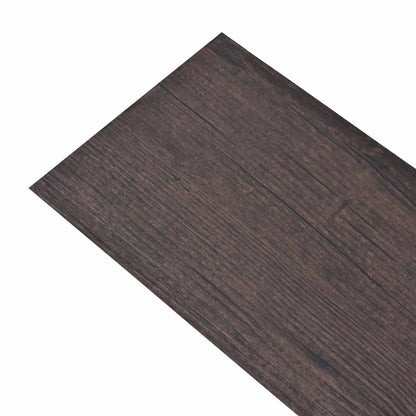 Close-up of the dark brown self-adhesive flooring planks with a realistic wood effect