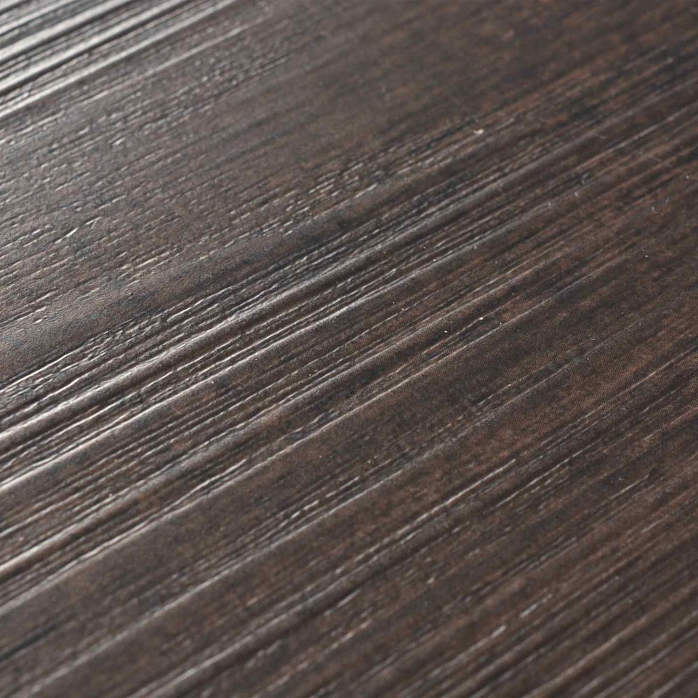 Extreme close-up of the dark brown self-adhesive flooring planks showing the surface texture