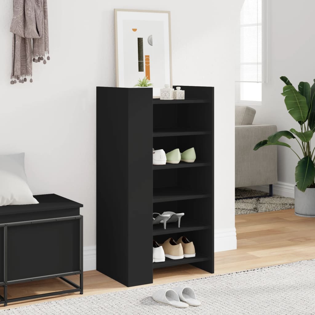 the black shoe storage unit in a hallway with shoes on the shelves