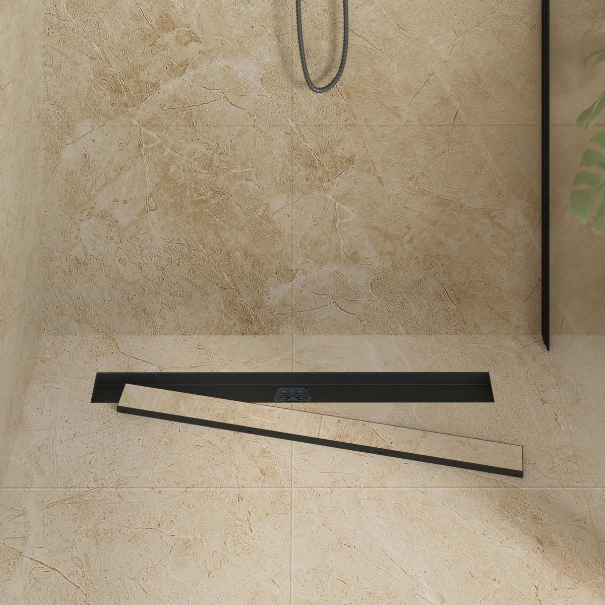 the shower drain with the tileable insert panel partially removed from the black frame