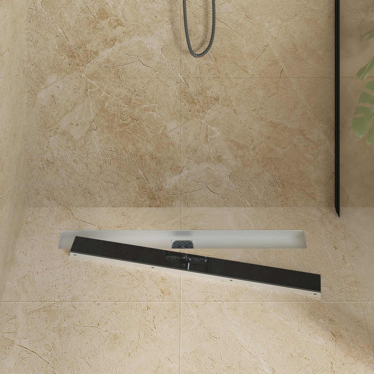 The black glass cover of a shower drain is lifted to show the internal components