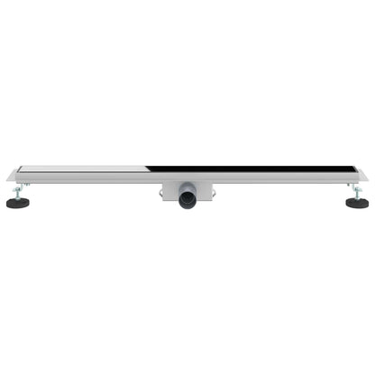 A long stainless steel shower drain with a black glass insert and outlet