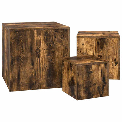 Three smoked oak engineered wood side tables grouped together on a plain background