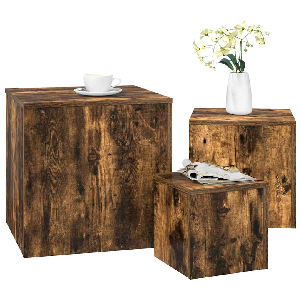 Three smoked oak engineered wood side tables, one with a cup and magazine on top