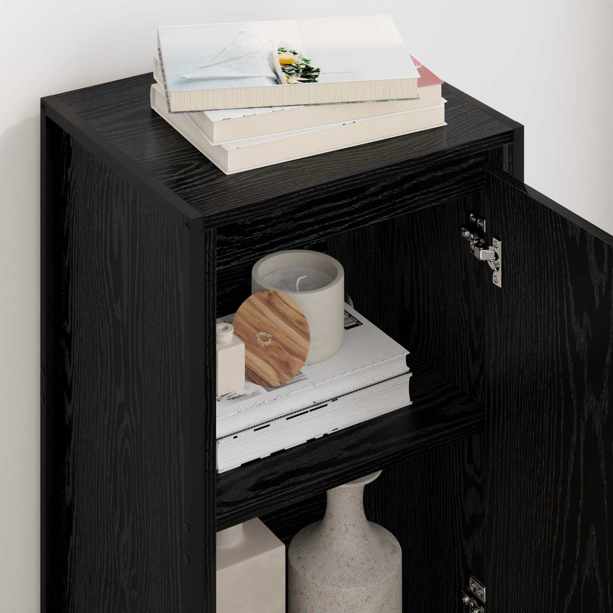 Close-up of the open black sideboard showing interior shelves with decor