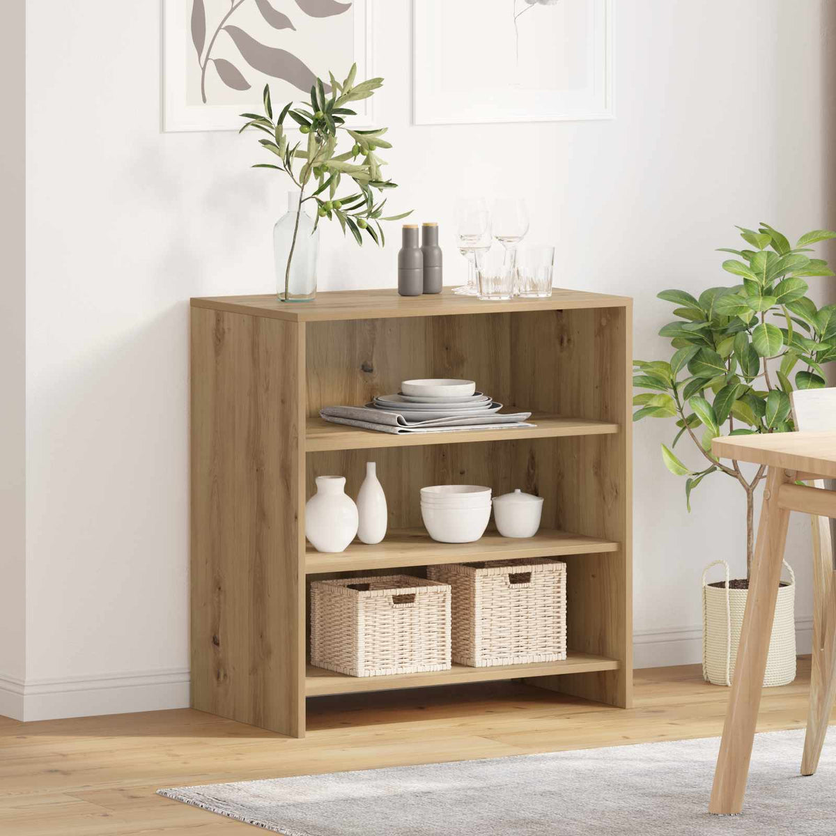 Buffet and sideboard in a dining room next to a table and plant