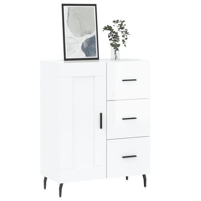 The white sideboard topped with a framed picture and a small plant in a glass vase