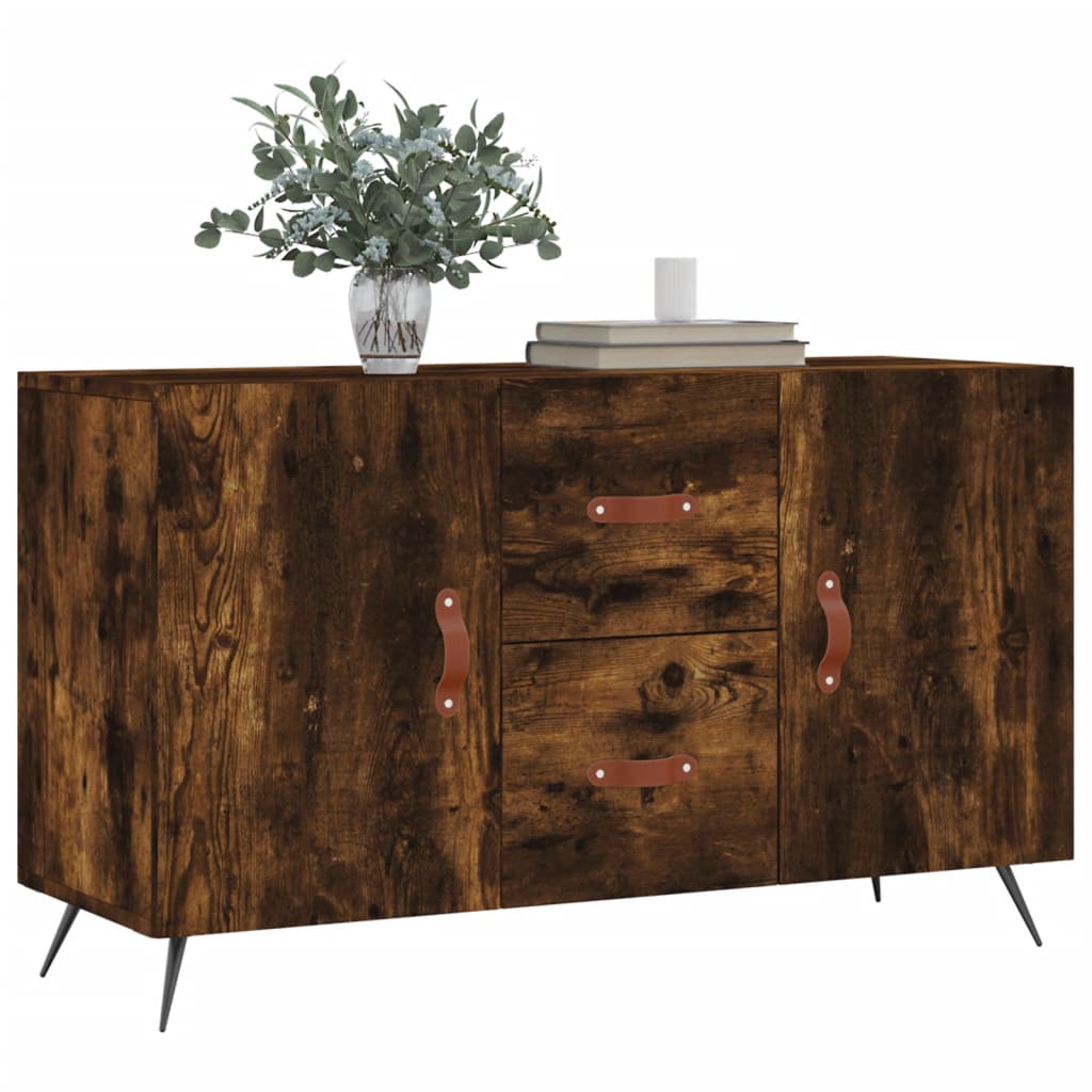 The wooden sideboard topped with a vase of greenery and books against a plain white backdrop
