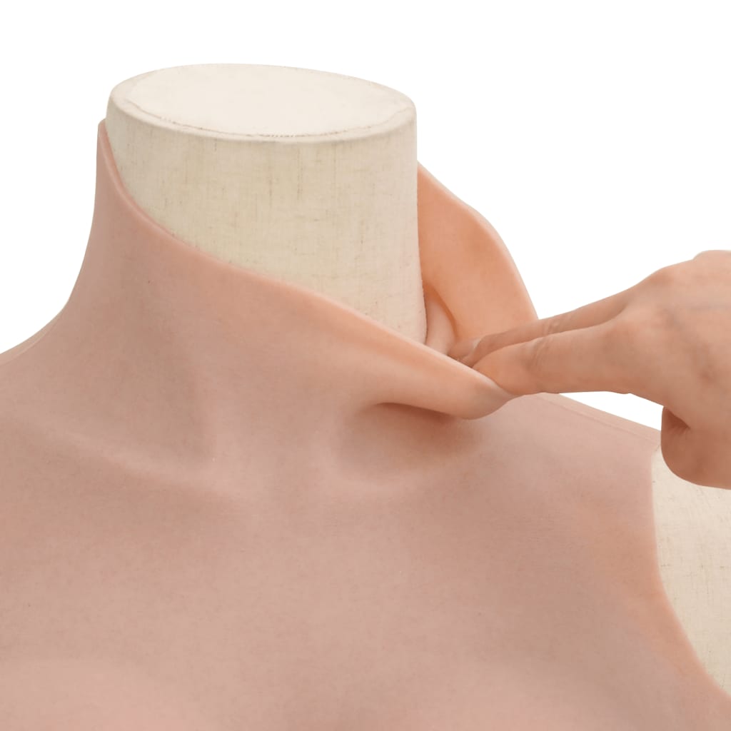 A hand gently stretches the silicone breastplate at the neck area to demonstrate its flexibility