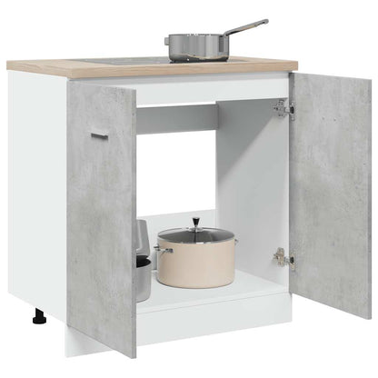 The sink base cabinet with its doors open showing storage space and pots