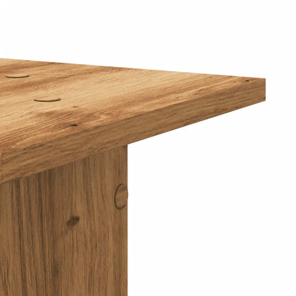 Close-up of the top surface of a speaker stand showing the wood grain