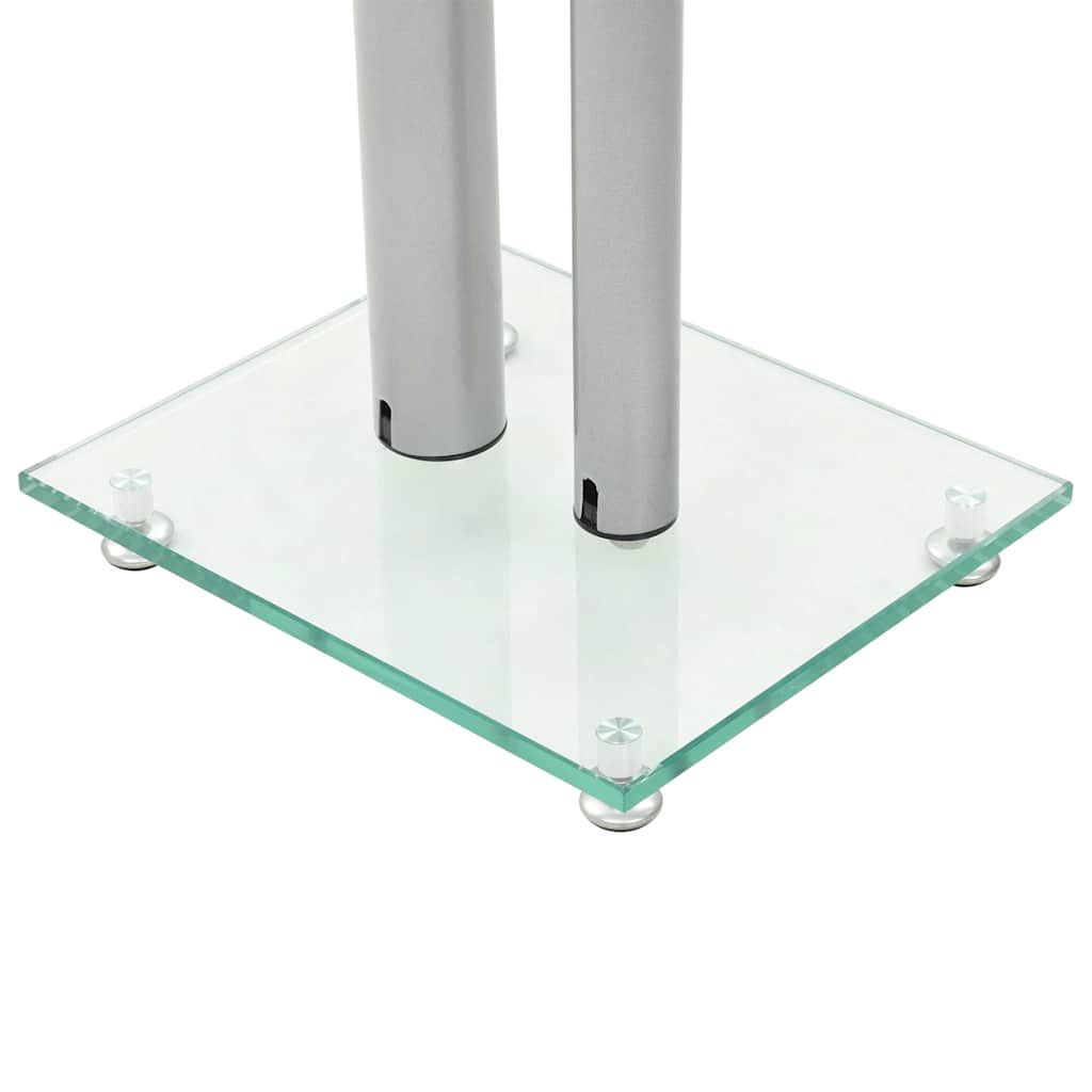 Close-up of the base of a speaker stand with tempered glass and silver pillars