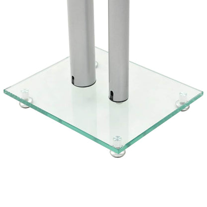 Close-up of the base of a speaker stand with tempered glass and silver pillars