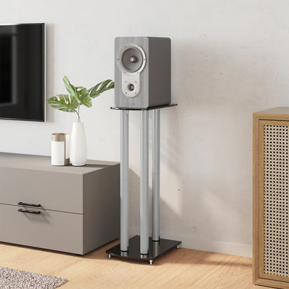 A single speaker stand holding a speaker in a domestic setting