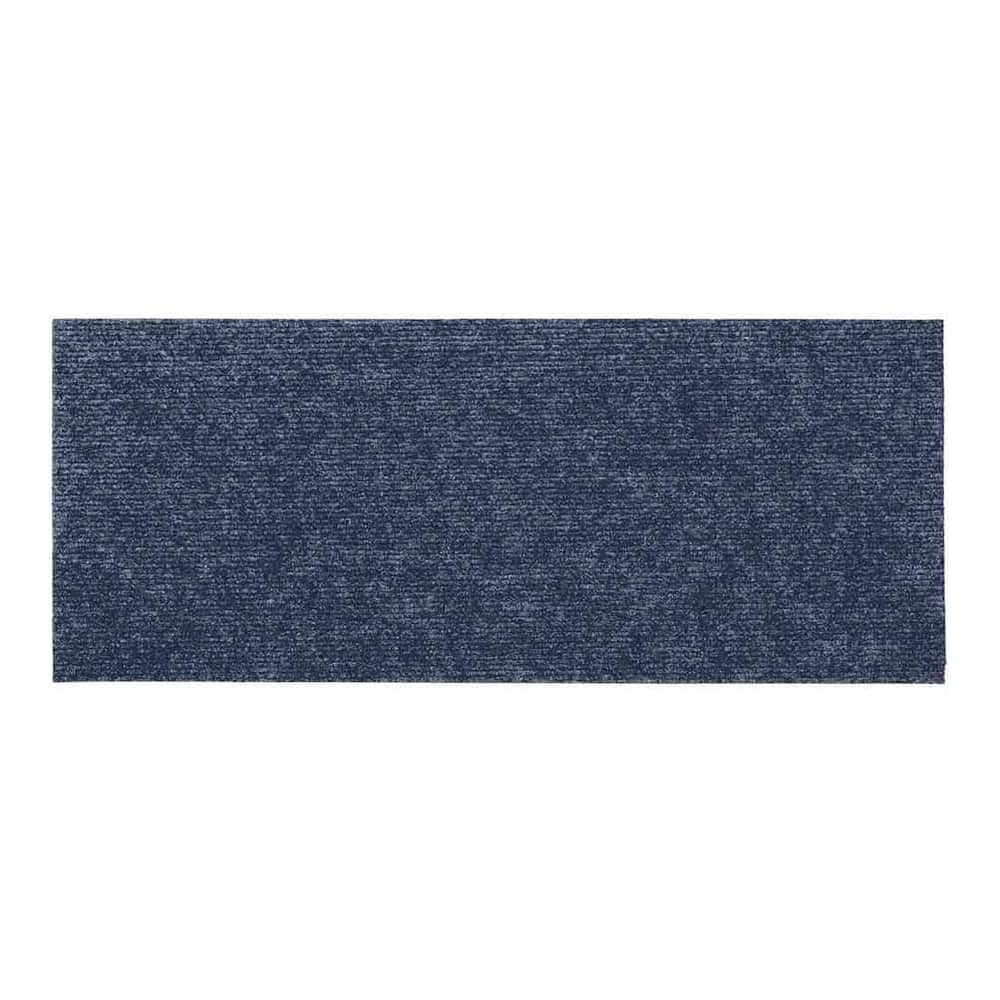 Close up of the textured surface of a grey blue rectangular stair tread