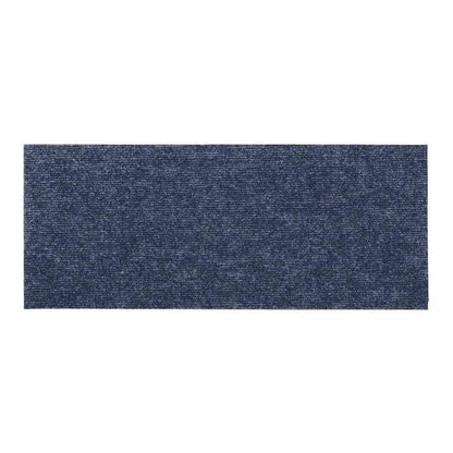 Close up of the textured surface of a grey blue rectangular stair tread