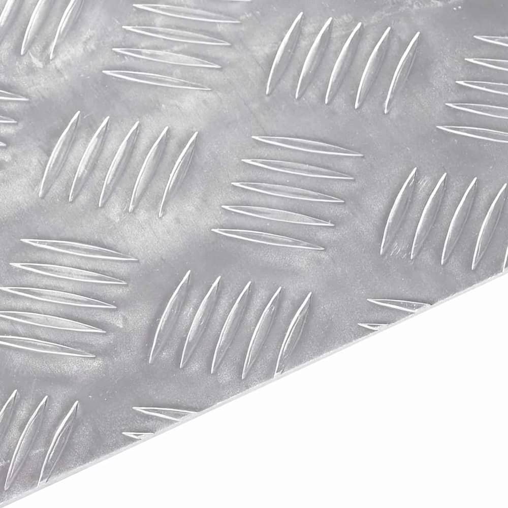 the stair tread showing a close up of the raised diamond pattern on the metal surface